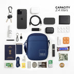 Flat lay of navy sling bag with 2.4L capacity, surrounded by essentials like keys, phone, and wallet.