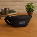 The Nexo Waist Pouch in black with 'COUNSELOR' text, showcasing a sleek design for everyday use.