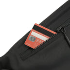 Close-up of the Nexo waist pouch showing a credit card in the hidden back zip pocket for secure storage.
