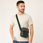 Man wearing the Noma Side Sling bag in black, showcasing its stylish and compact design.