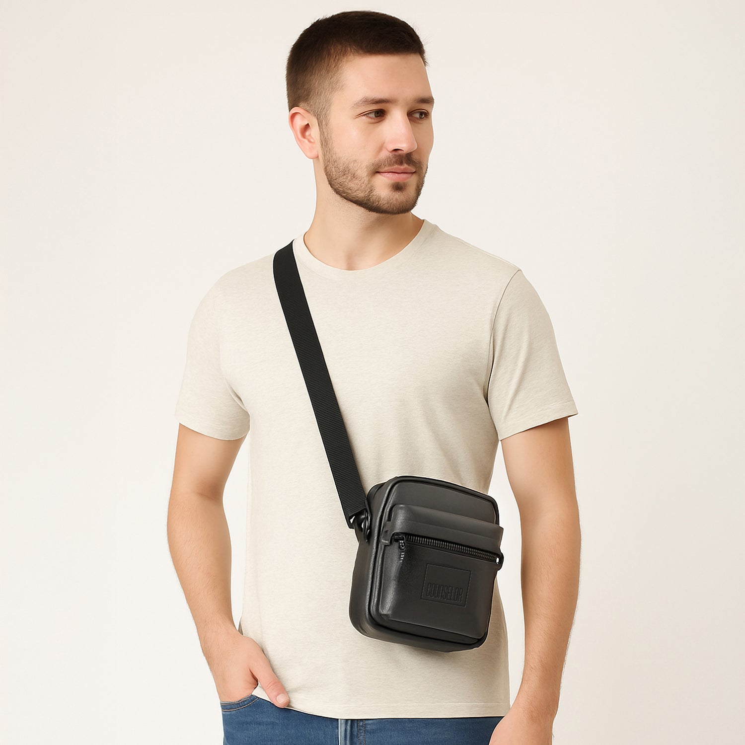 Man wearing the Noma Side Sling bag in black, showcasing its stylish and compact design.