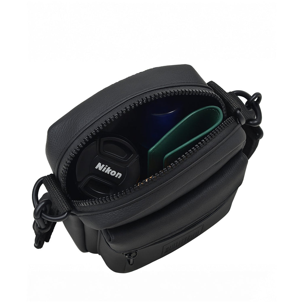 Open view of the Noma Black bag showing Nikon camera accessories inside, highlighting its compact design and efficient organization.