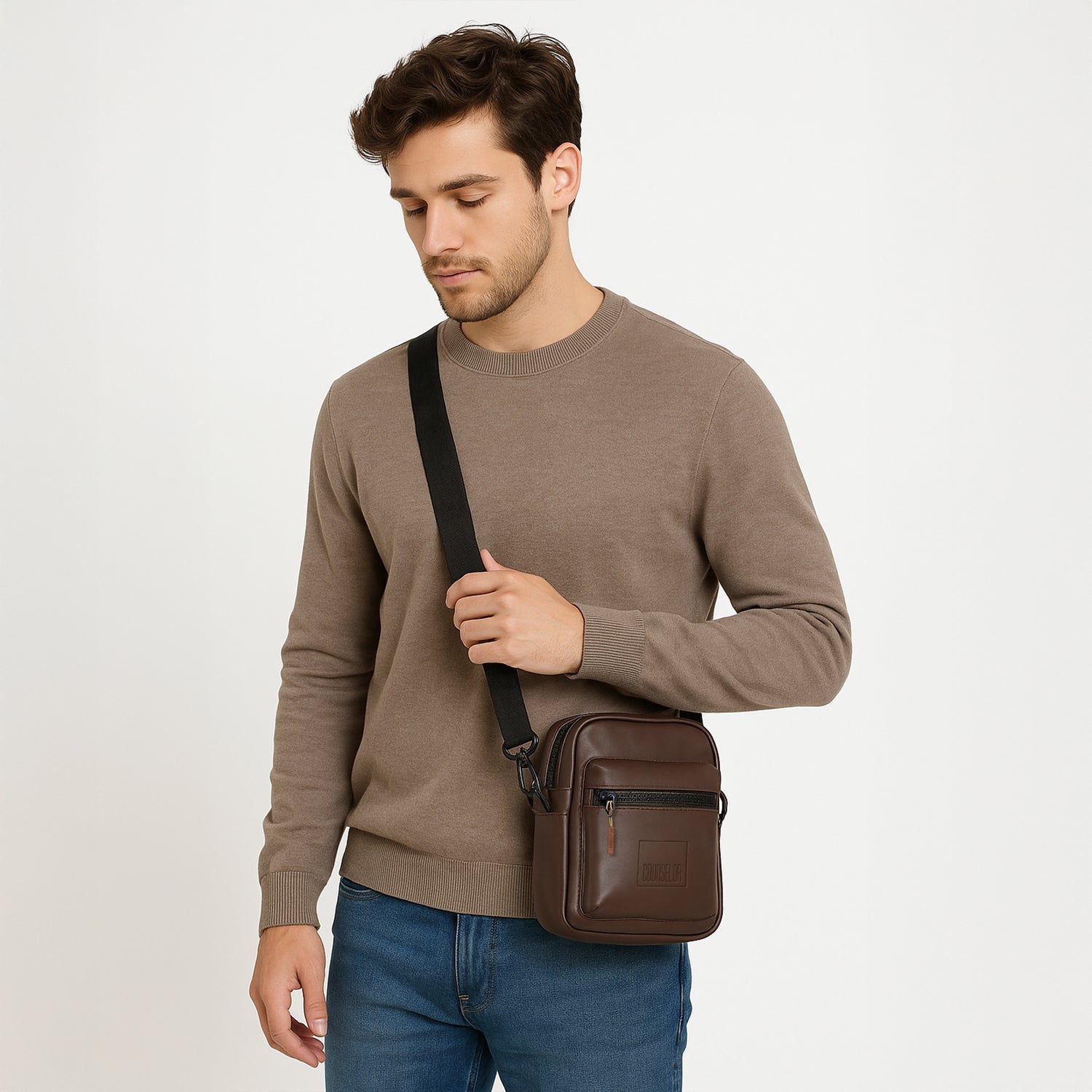 Model wearing The Noma brown sling bag, showcasing its stylish design and adjustable strap.
