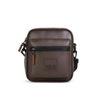 NOMA brown vegan leather bag with front zipper pocket and adjustable strap, perfect for travel and daily use.