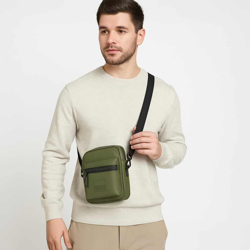 Man wearing the Noma - Olive bag, a stylish and eco-friendly sling bag made from vegan leather.