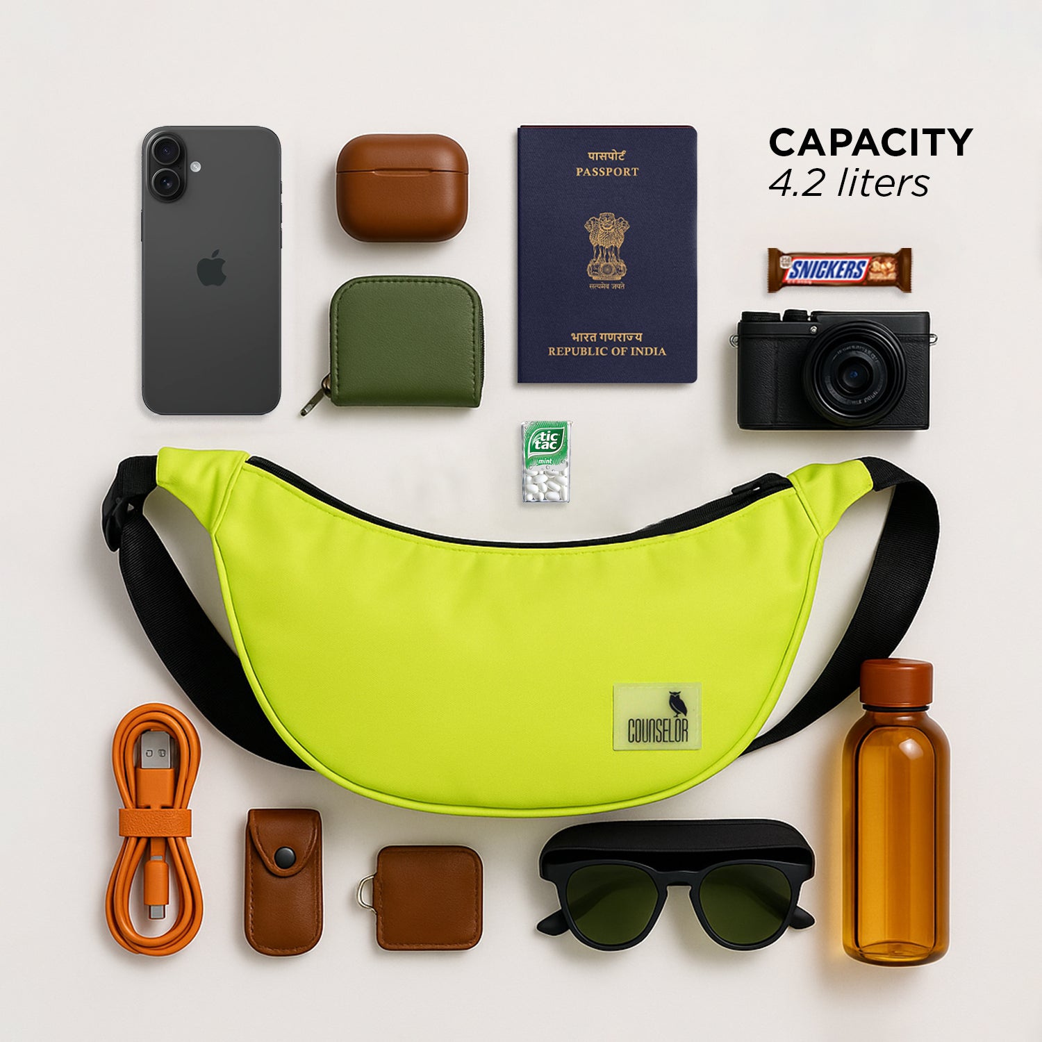 The Zuki lime green sling bag with everyday essentials like phone, passport, and camera, showcasing its 4.2-liter capacity.